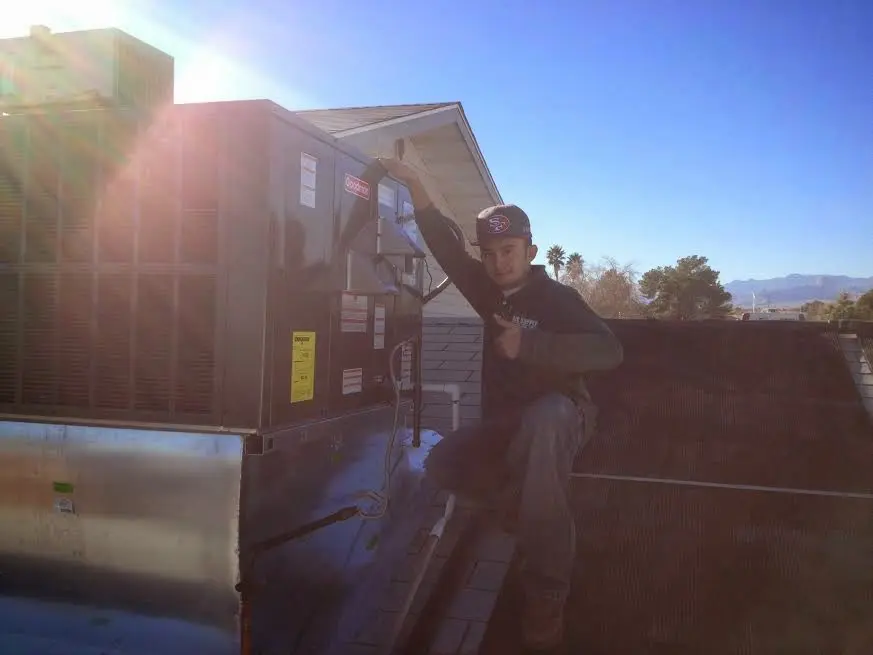 HVAC technician performing Boiler Repair on a rooftop unit in Somerset